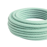 Câble textile rond en coton Lait menthe – rouleau vu de trois quarts