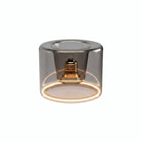 Ampoule LED donut E27 en verre fumé Ø 120 mm allumée, anneau lumineux ambré, fond blanc