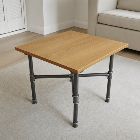 Piètement de table basse en croix, fonte et acier vernis Ø 27 mm, en situation sous un plateau en chêne huilé clair