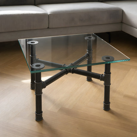 Piètement de table basse en croix, fonte et acier vernis Ø 34 mm, en situation sous un plateau en verre trempé